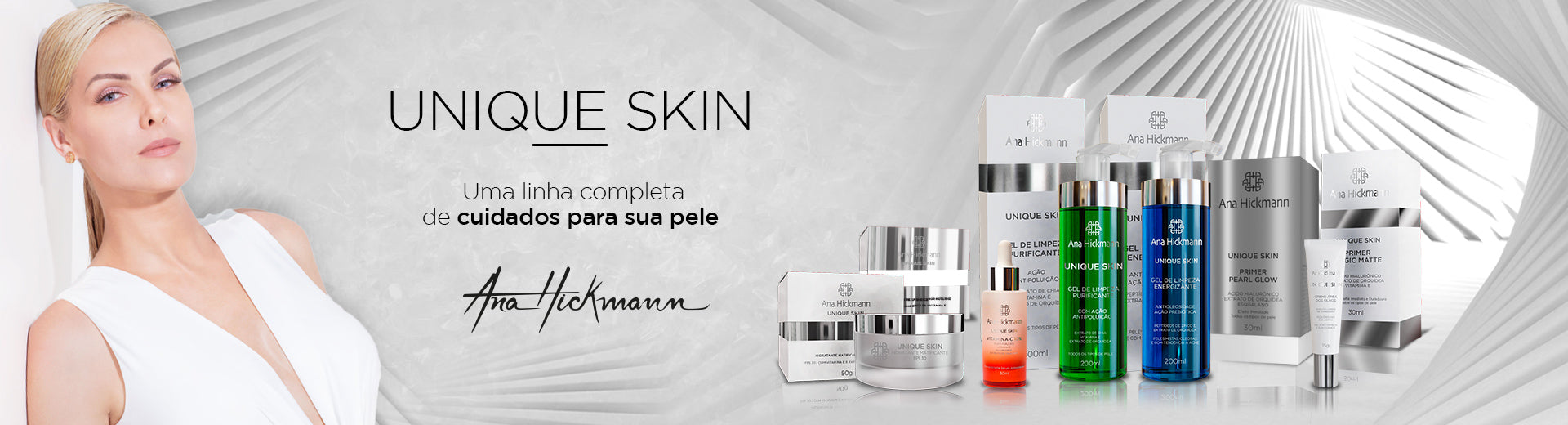 Ana Hickmann de branco ao lado da linha Unique Skin completa, com géis de limpeza, sérum de vitamina C, hidratantes e primers